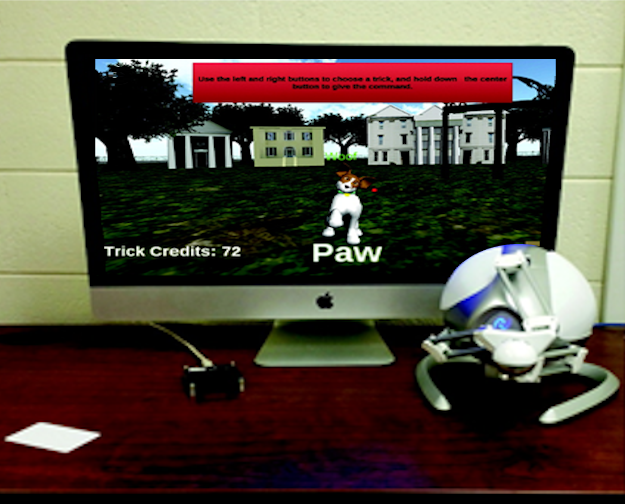 Virtual dog on a screen with a haptic joystick controller.